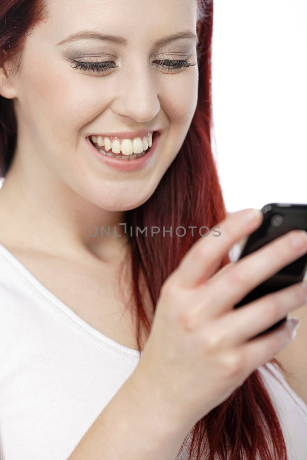 Happy smiling young woman reading texts and laughing.