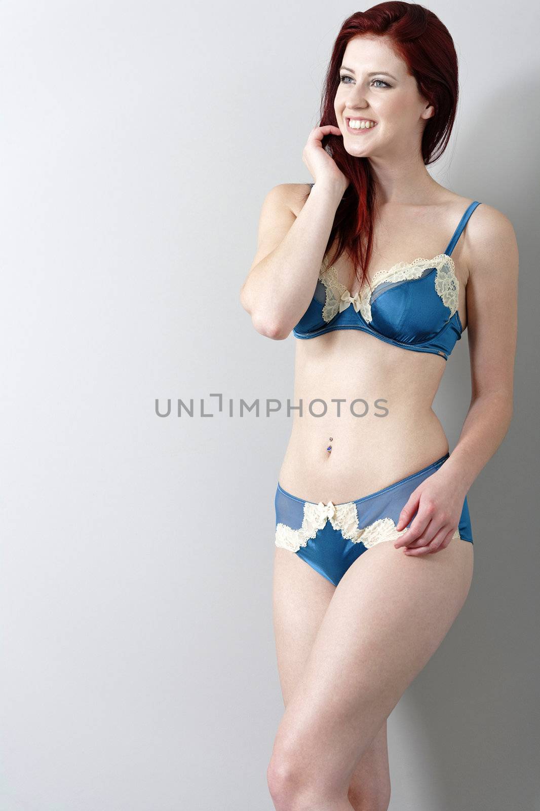 Smiling woman in blue underwear by studiofi