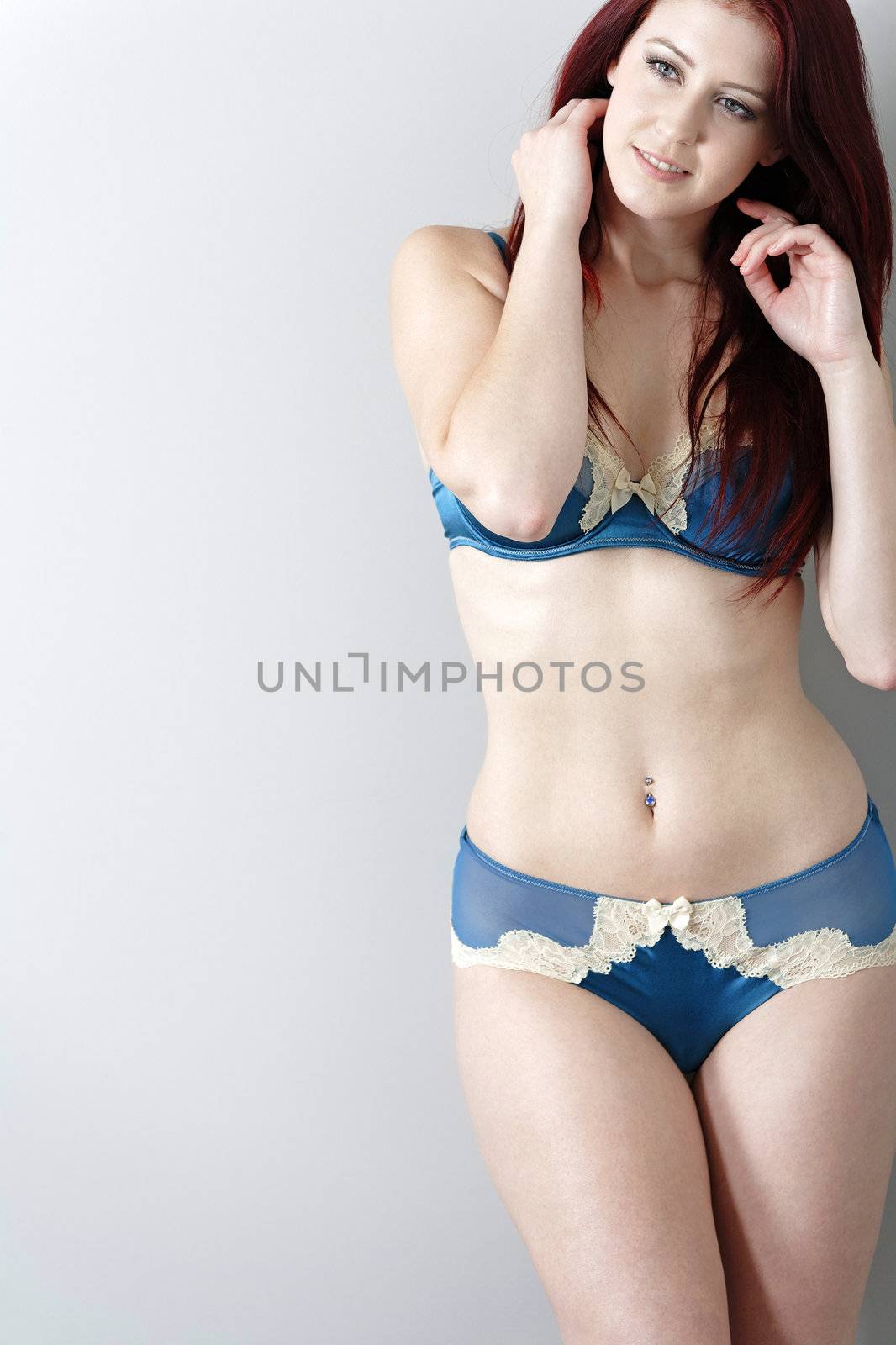 Smiling woman in blue underwear by studiofi