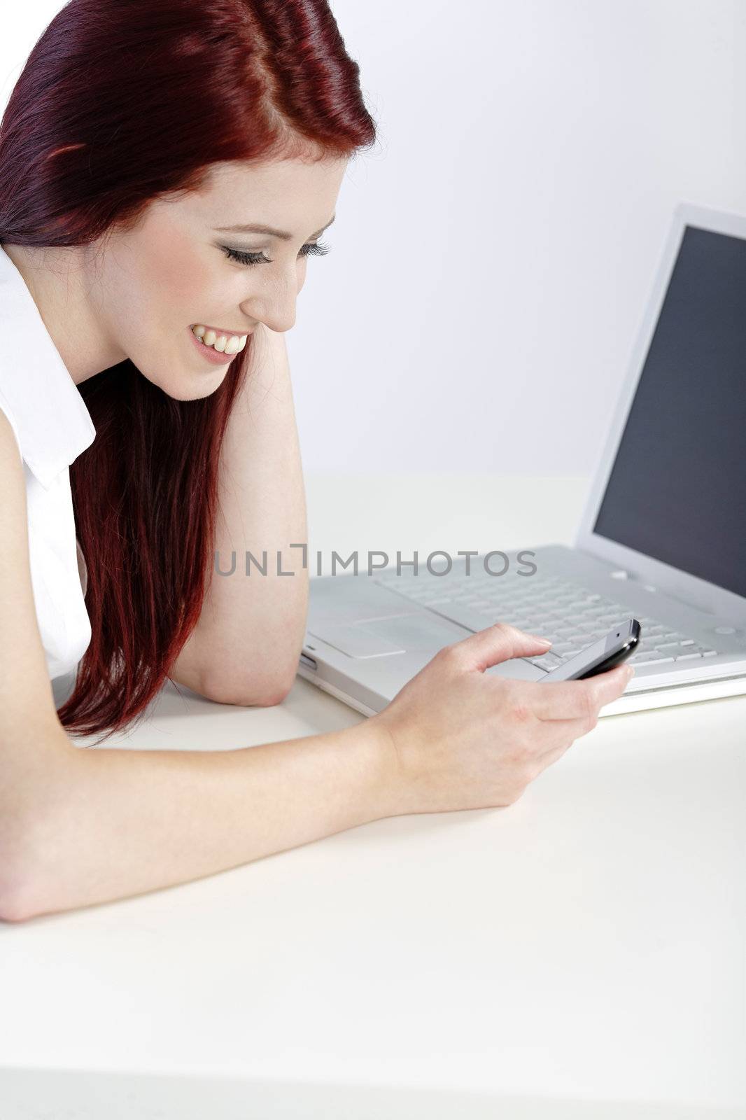 Young woman using her mobile phone at work