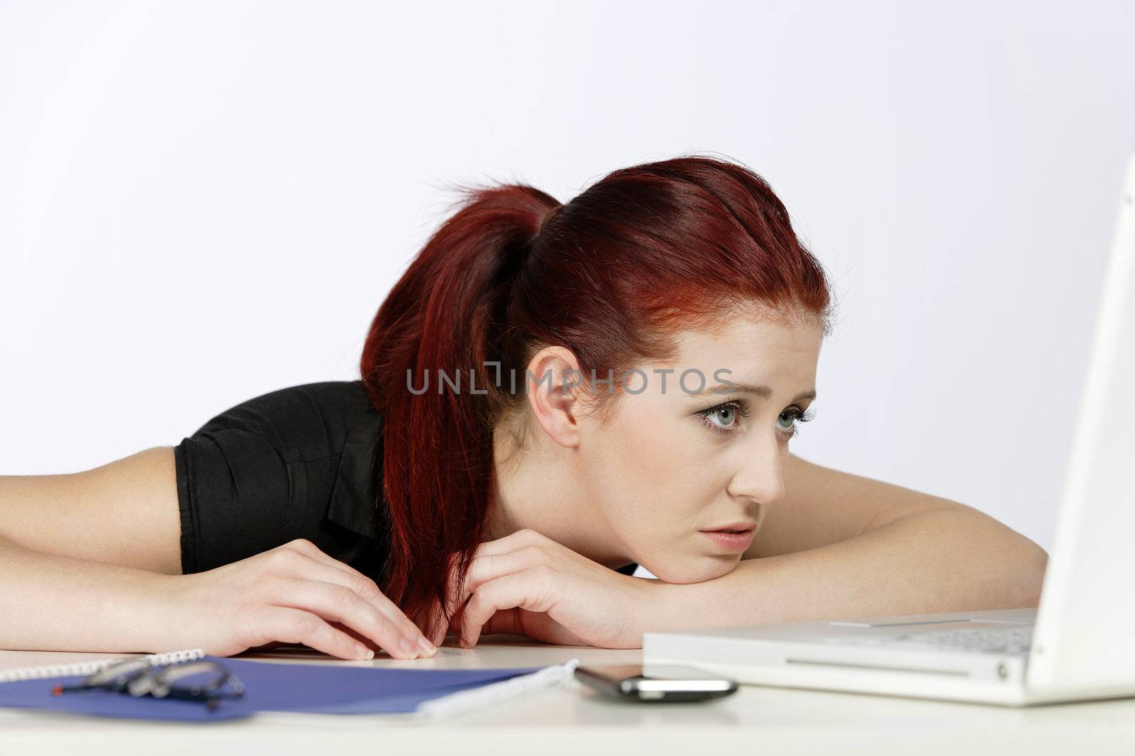 Professional woman showing concern at work using her laptop