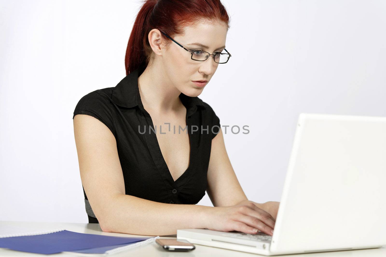 Professional woman showing concern at work using her laptop