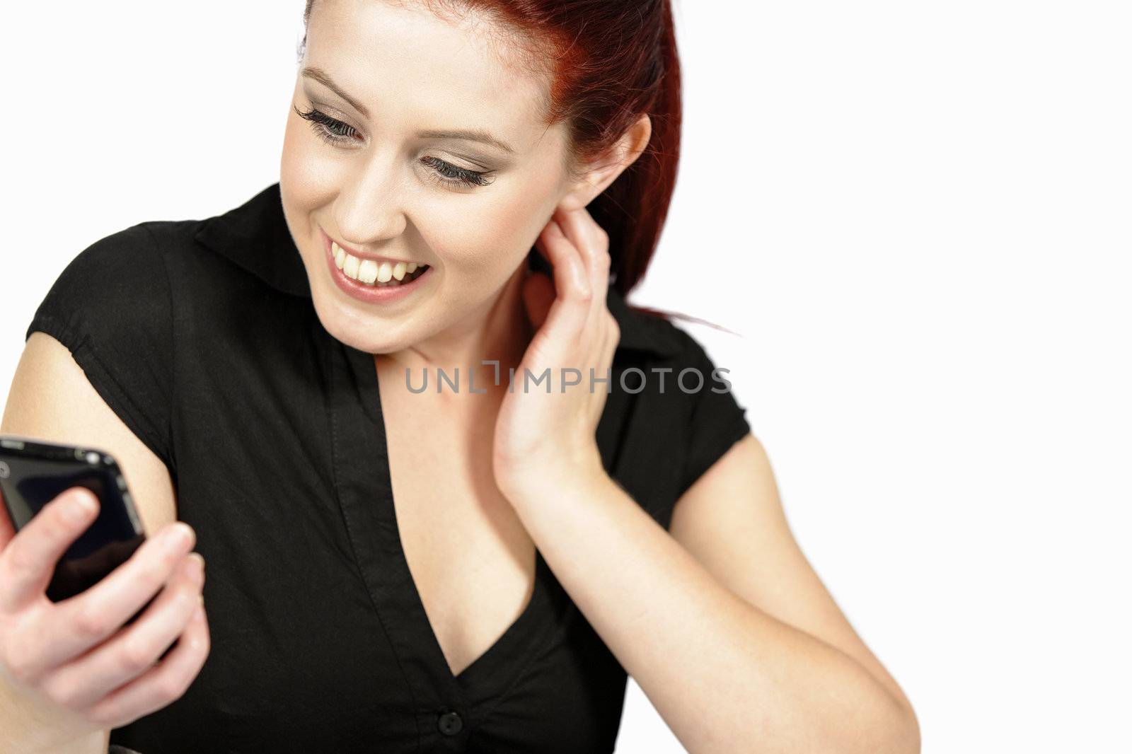 Professional young woman receiving good news on her mobile at work