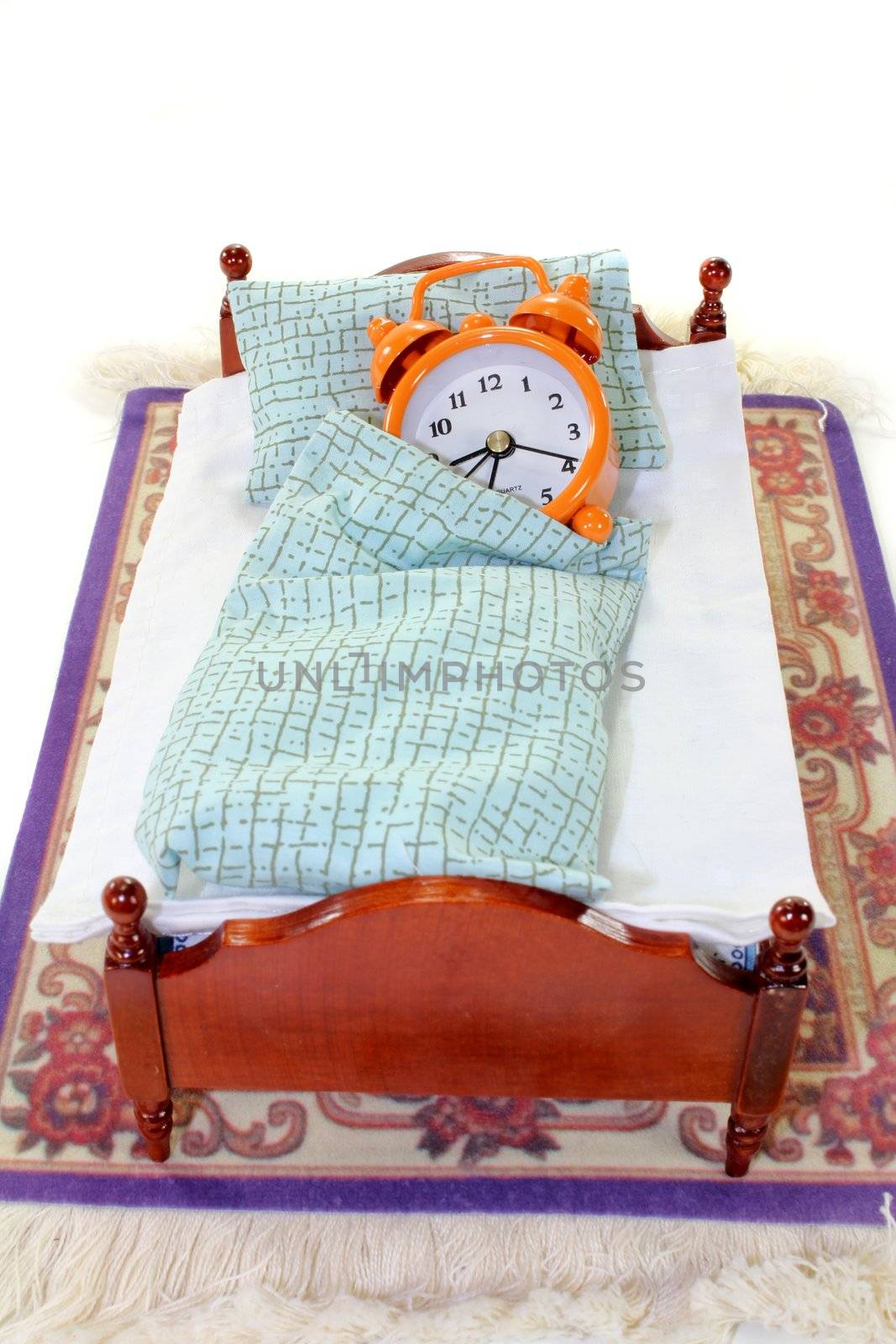 a wooden bed and alarm clock on a white background