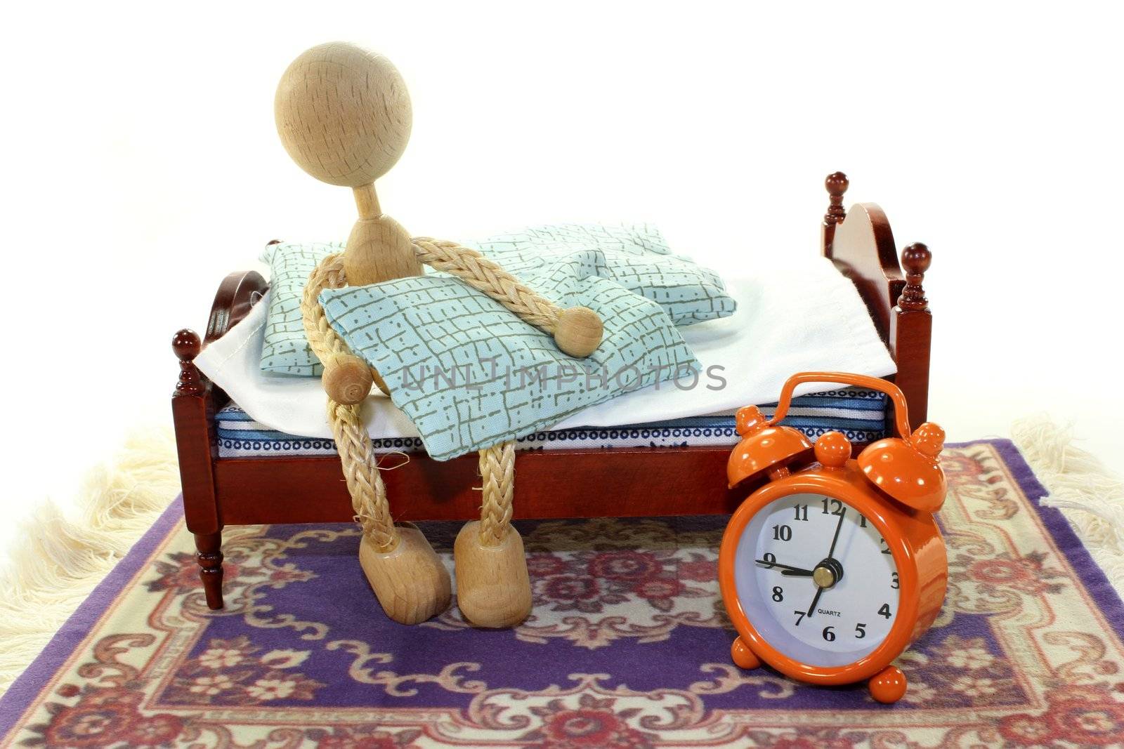 a wooden bed and alarm clock on a white background