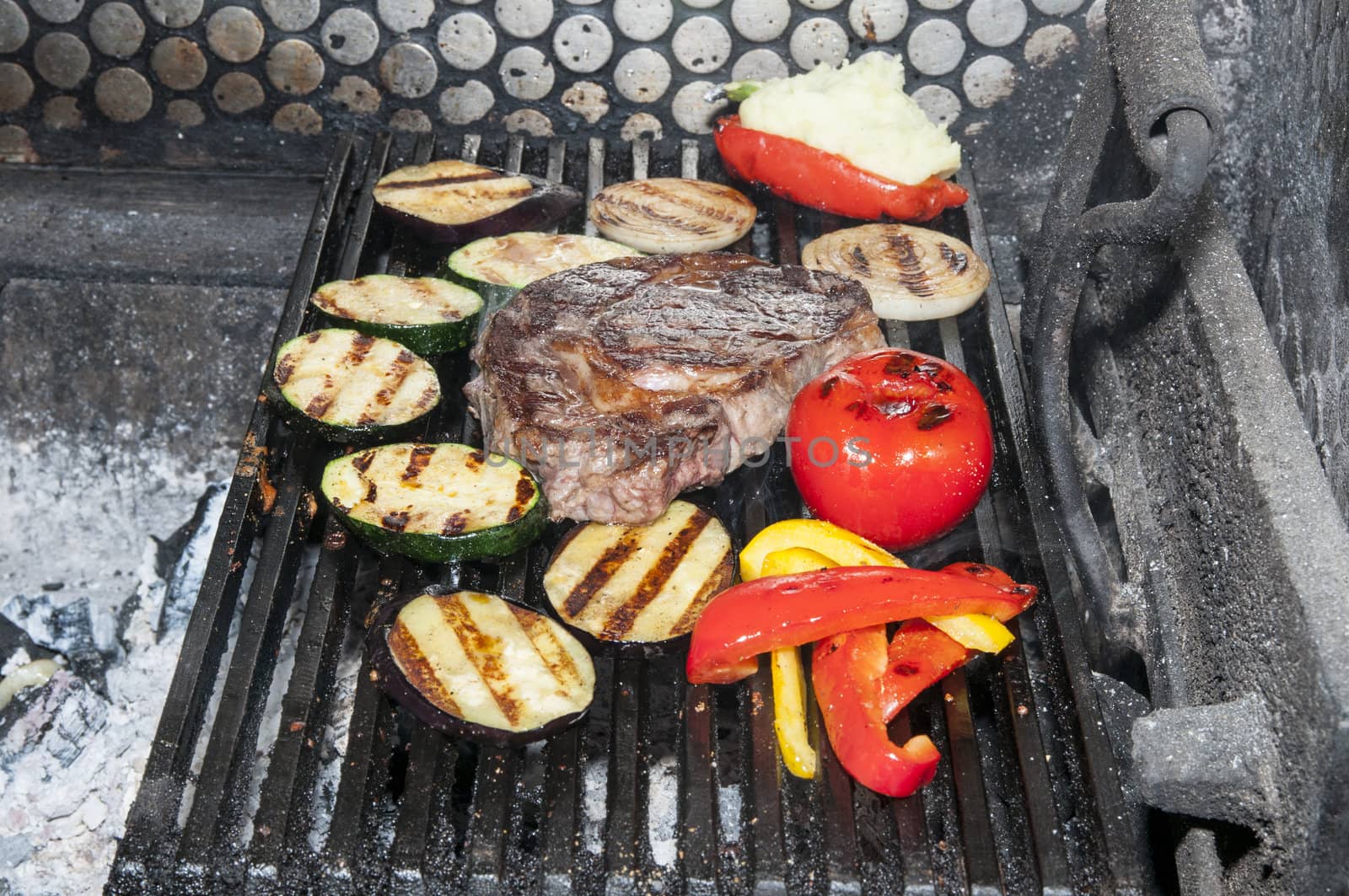 cooking steak and vegetables on the grill