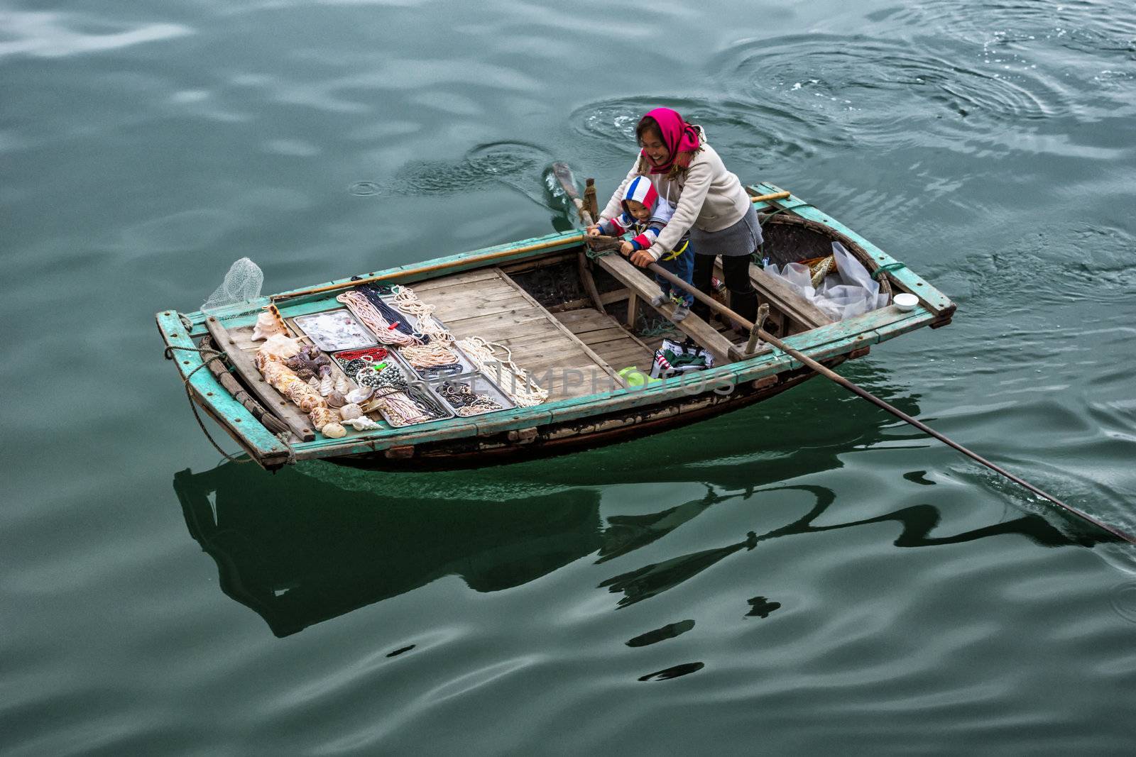 Vietnam Halong Bay. Action photo of happy couple working together making money.
