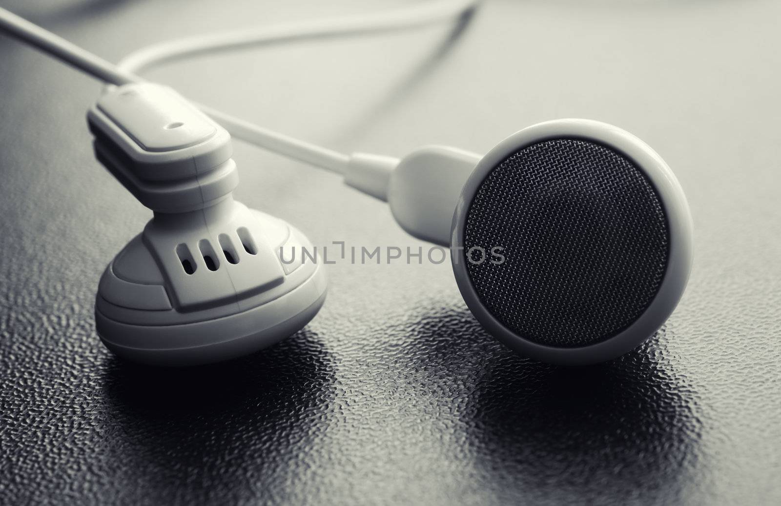 Macro image of headphones on wood texture