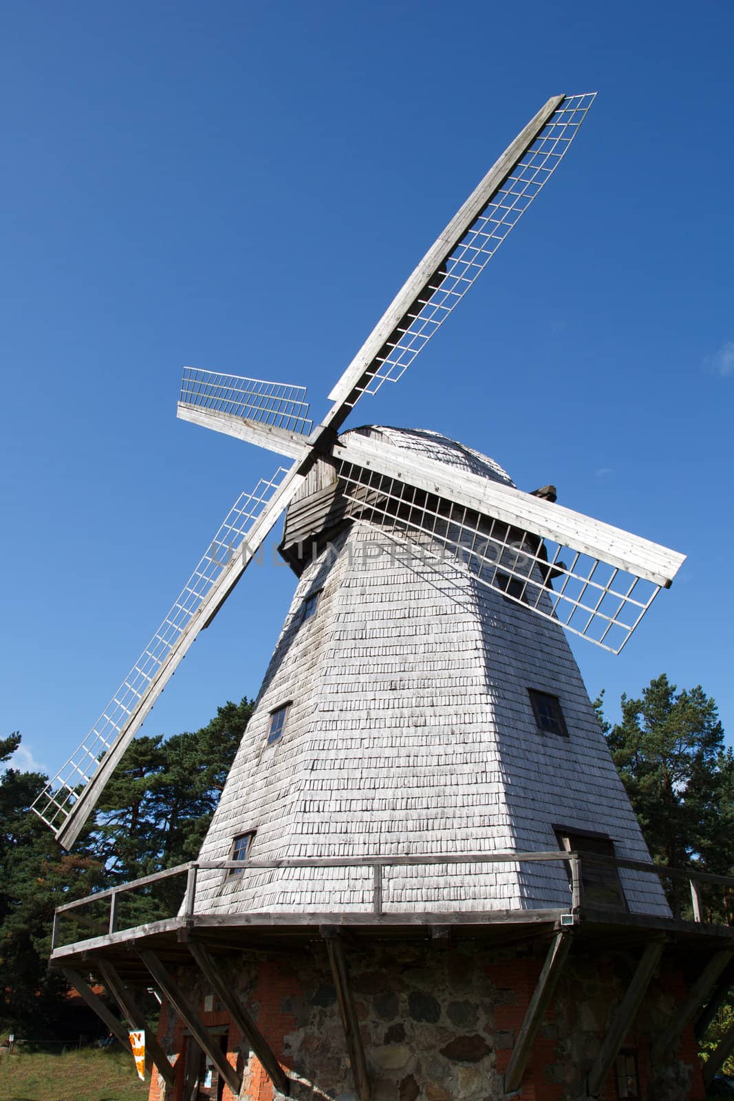 old traditional windmill against a blue sky