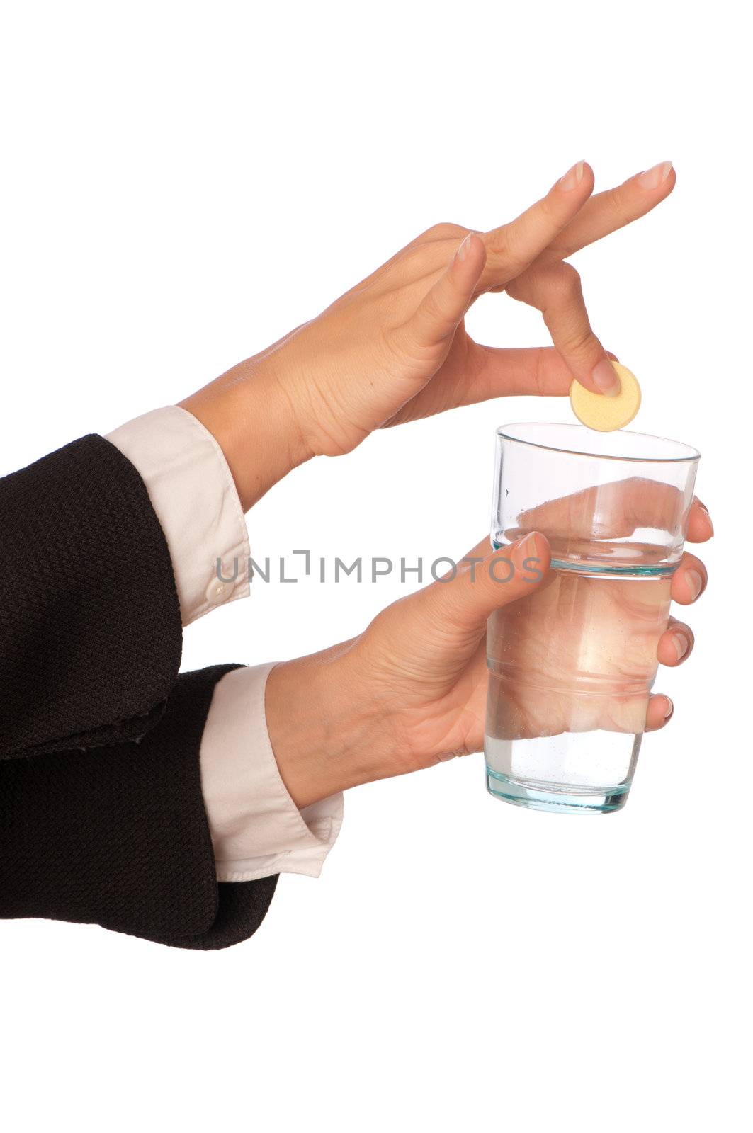 Businesswoman throws a vitamin pill to the glass with water
