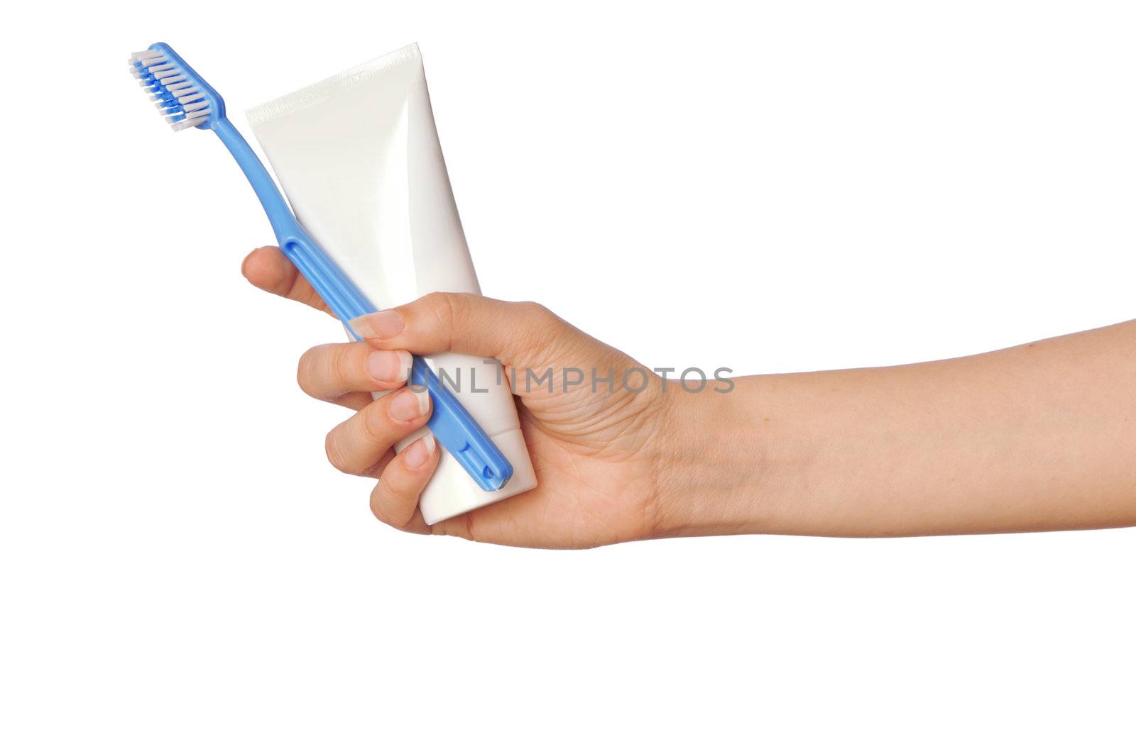 Tooth-paste and brush at in the girl's hand