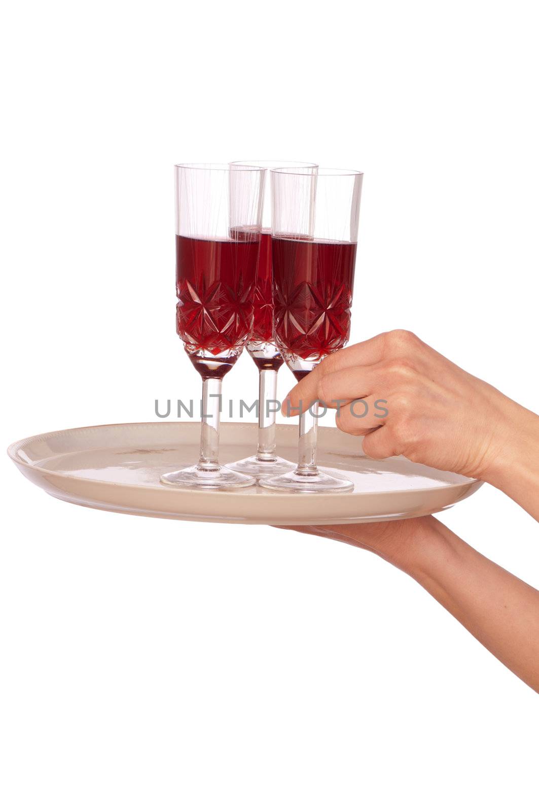 A waiter takes a glass of champaigne from a tray with three glasses
