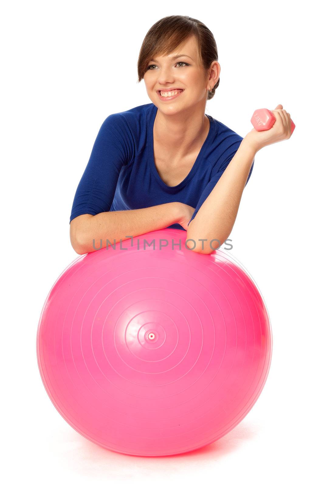 Instructor taking exercise class using ball and dumbbells at gym