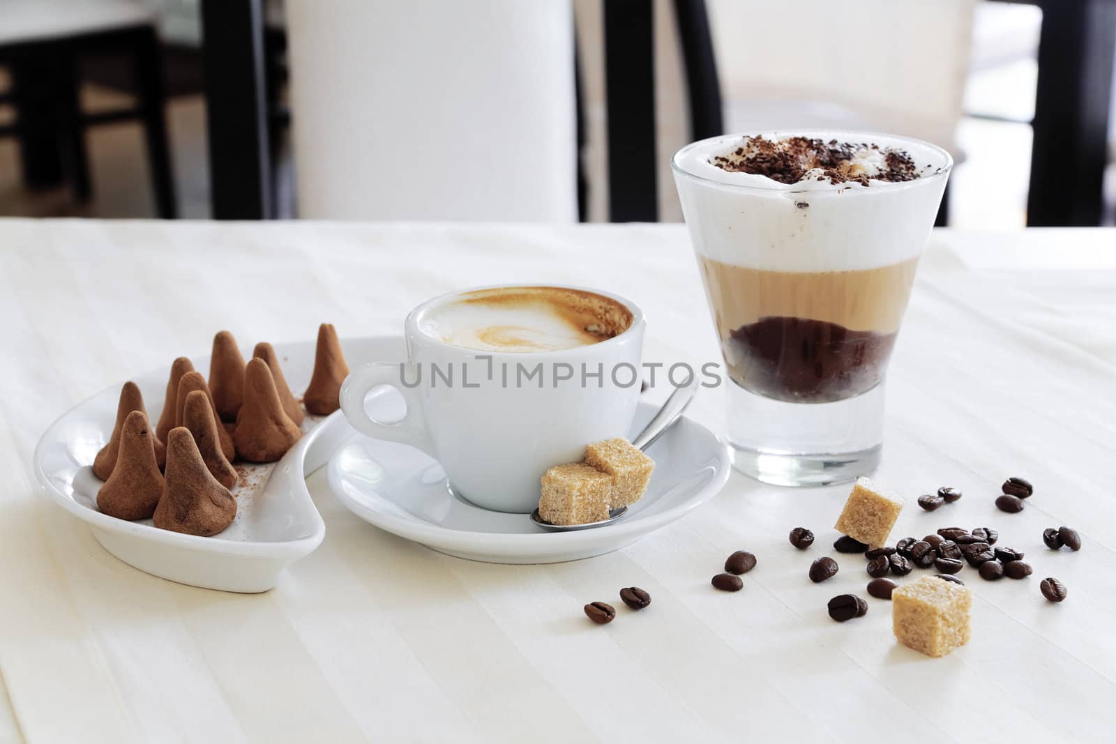 Appetizing coffee and sweets on a table in modern cafe