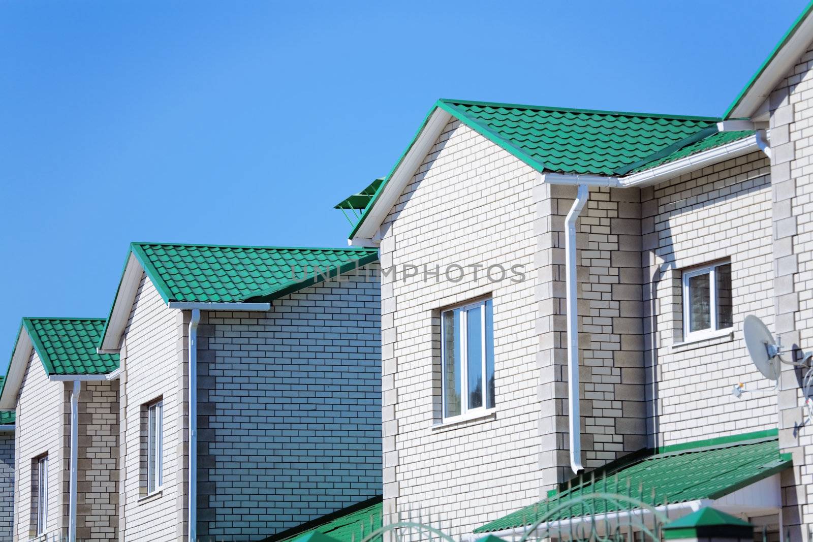 Facades of modern brick townhouses in suburb