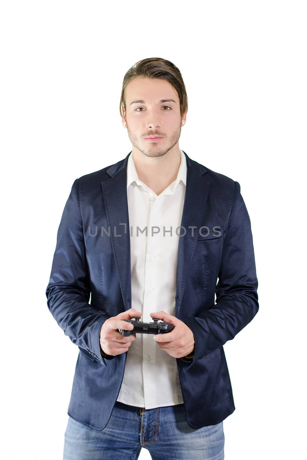 Young man playing videogames with joypad or joystick, standing and isolated on white