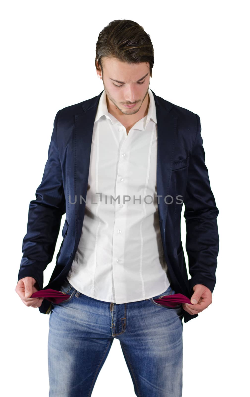 Broke young man looking at empty pockets by artofphoto