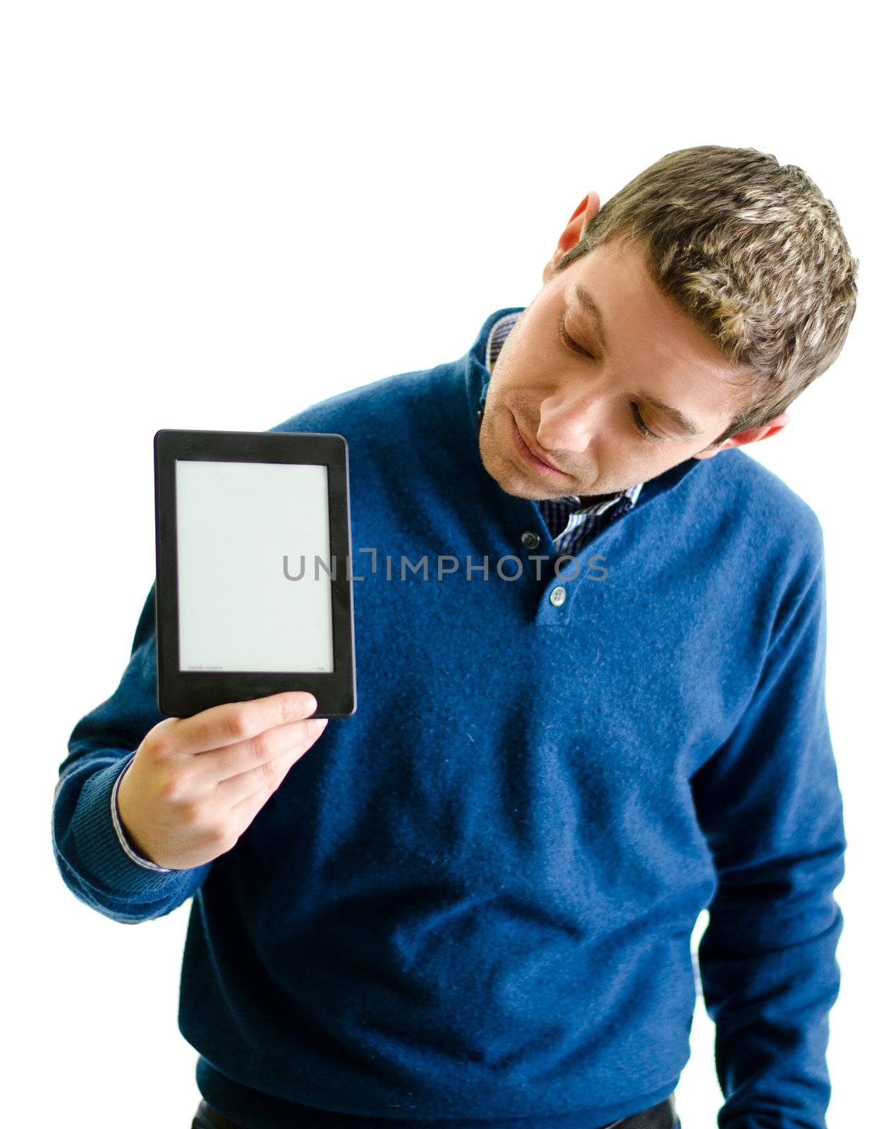 Young man looking at ebook reader by artofphoto