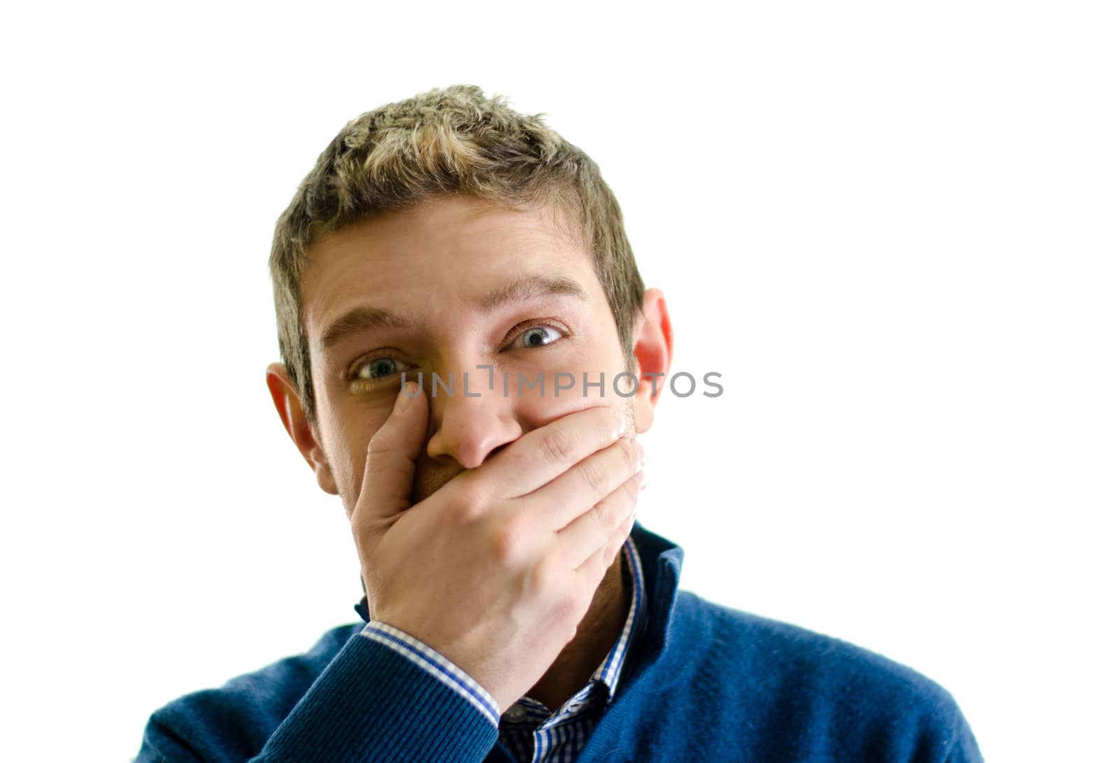 Handsome young man covering his mouth with hand, not laughing or in silence
