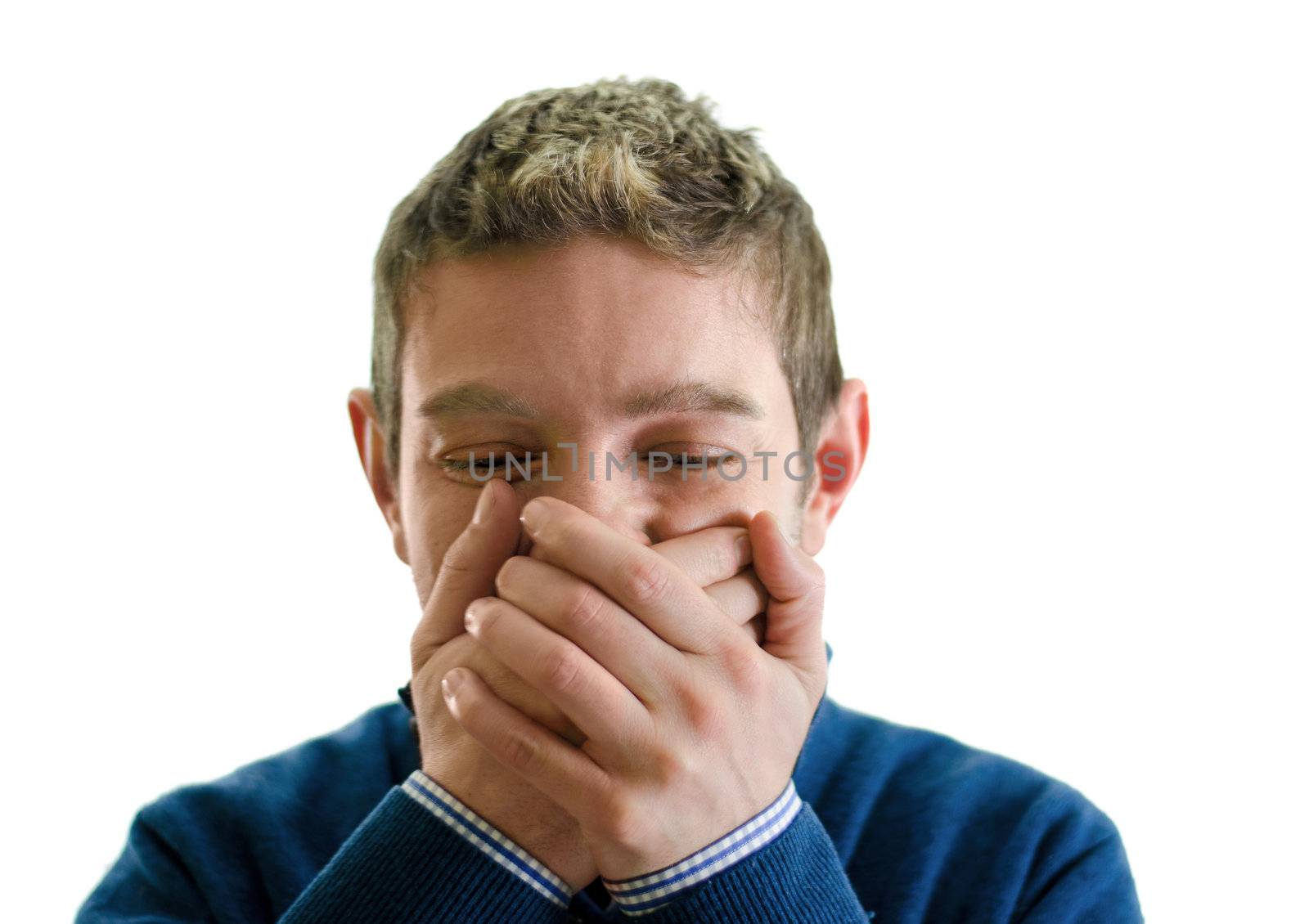Young man covering his mouth with hands, trying not to laugh