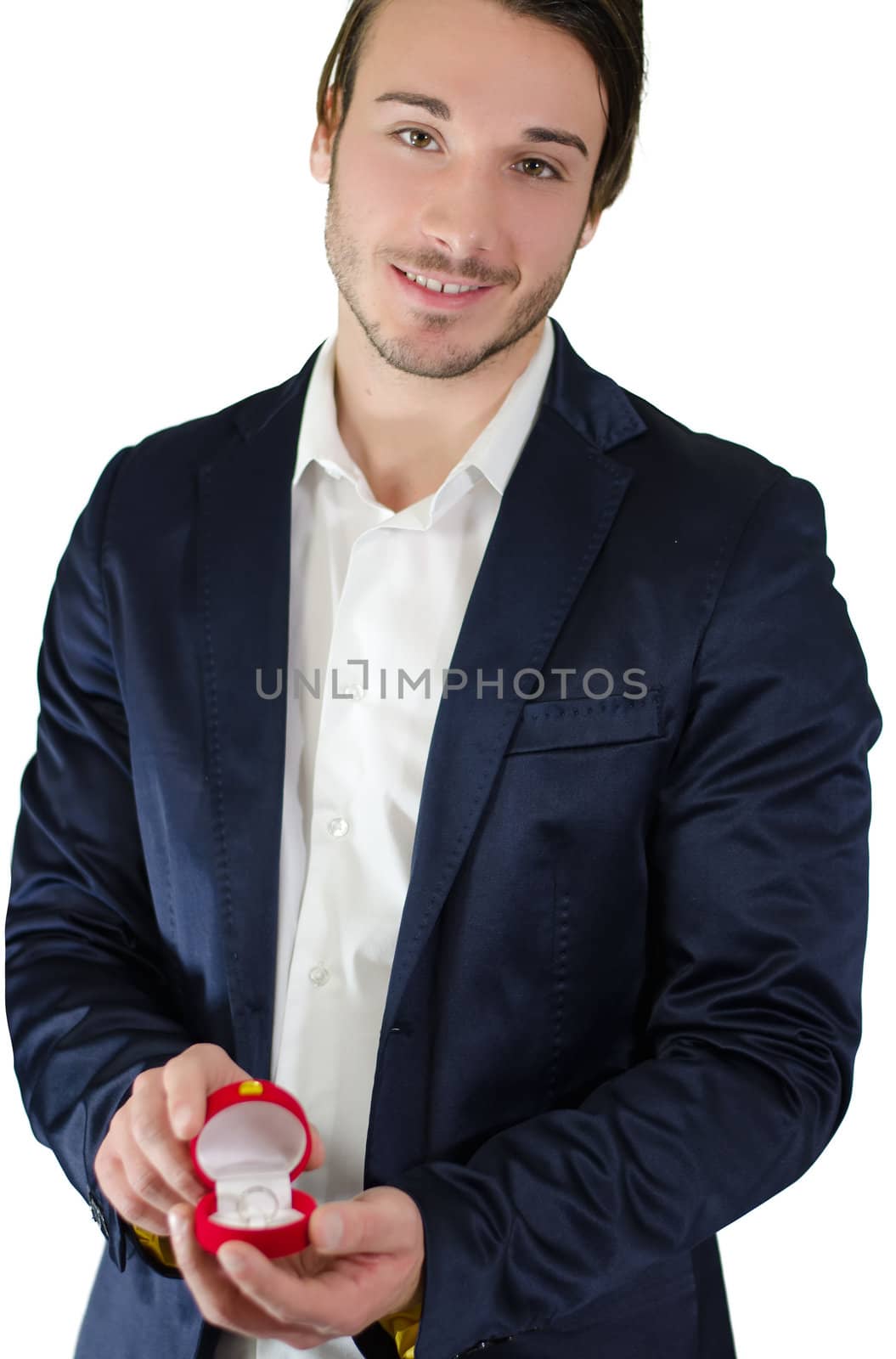 Handsome young man with engagement ring box in his hands, isolated on white