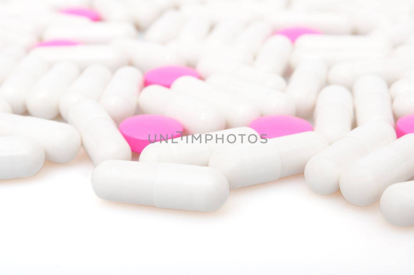 Medical Pink Pills and White Capsule On White Background