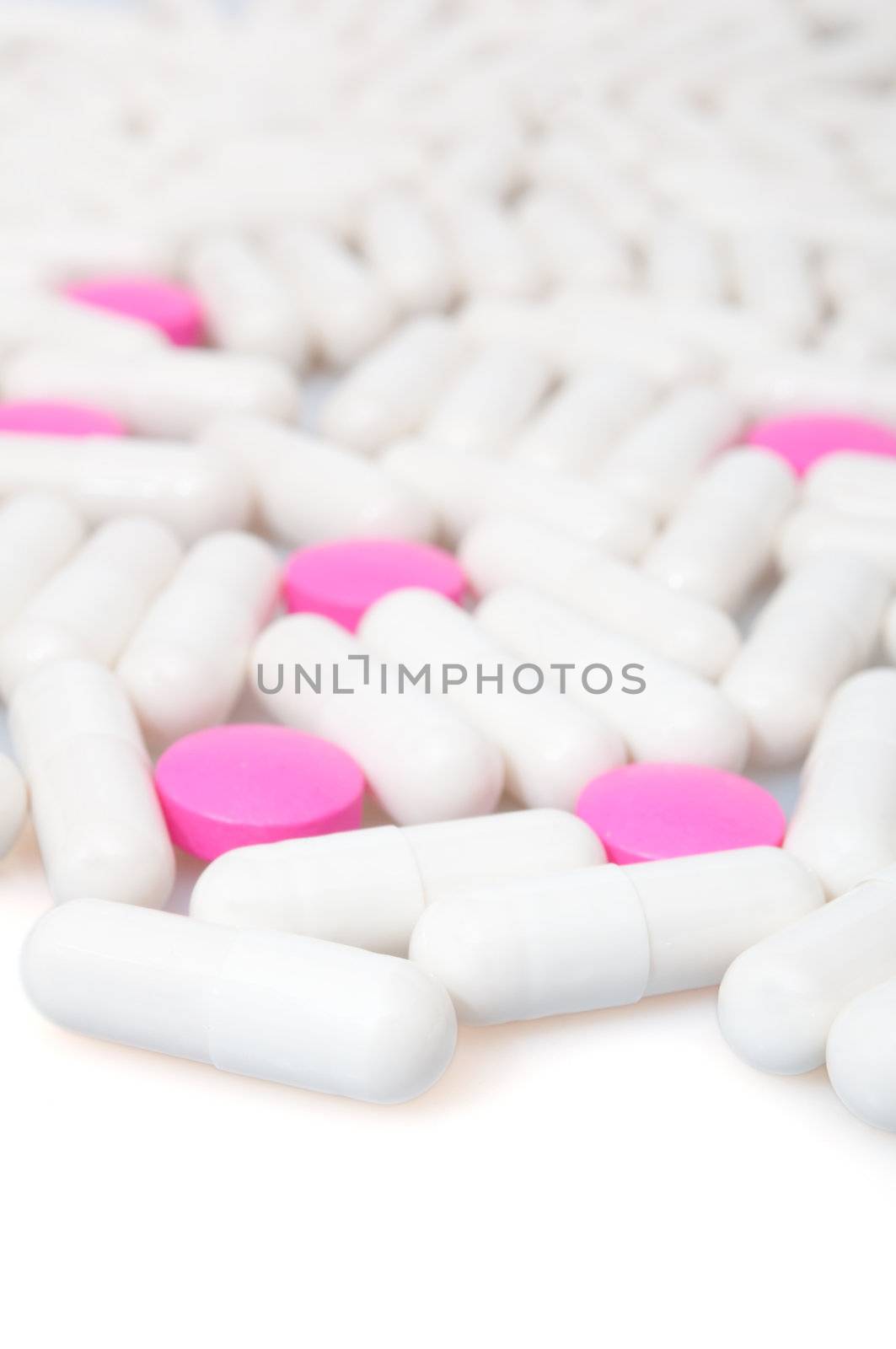 Medical Pink Pills and White Capsule On White Background