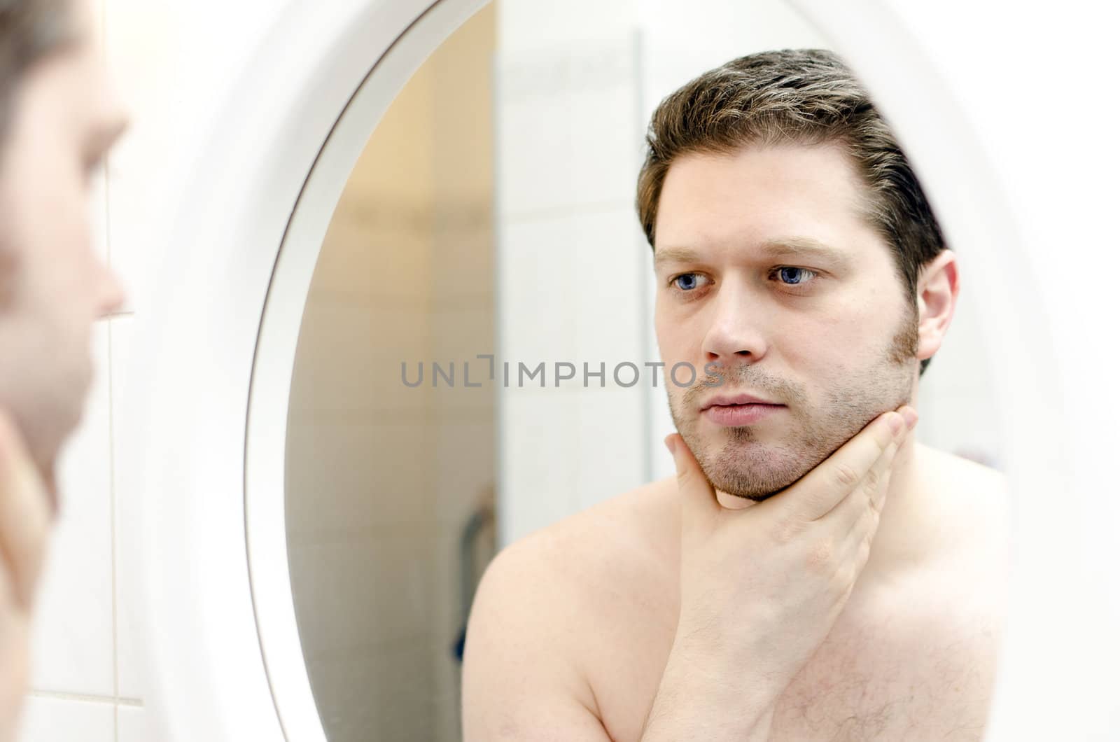 Man looks at his beard and thought about shaving