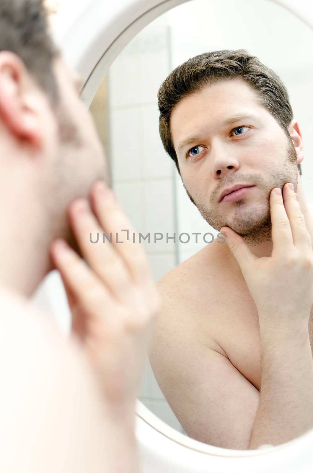 Man looks at his beard and thought about shaving