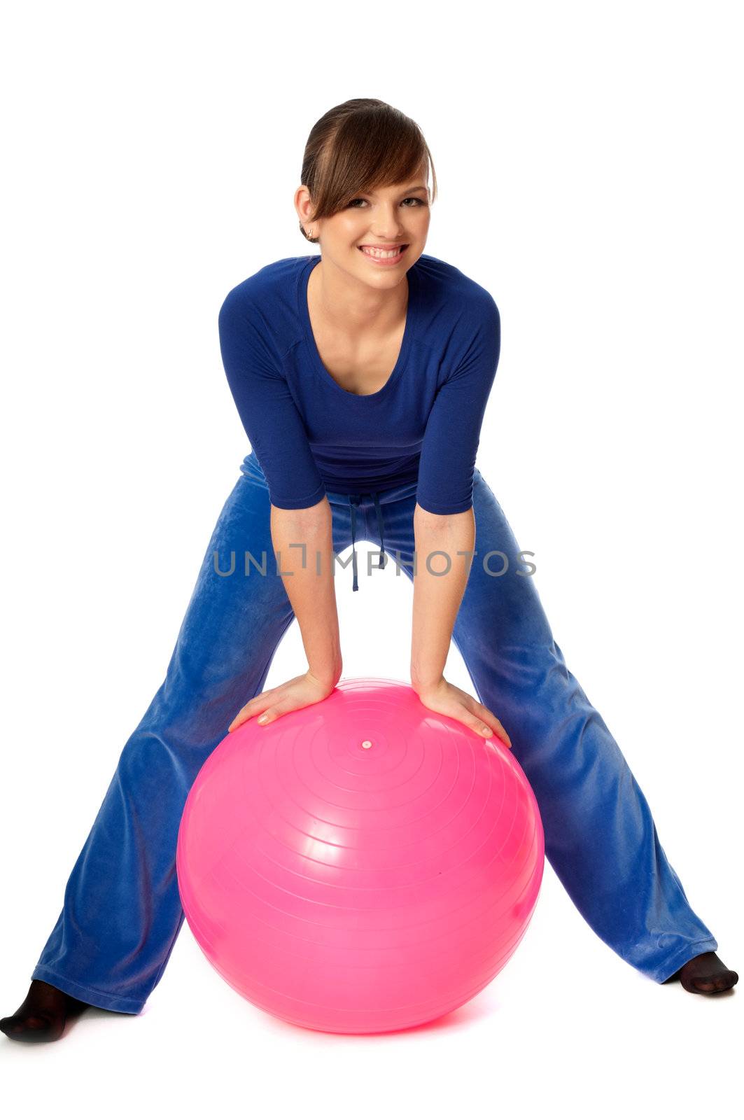 Instructor taking exercise class using ball and dumbbells at gym