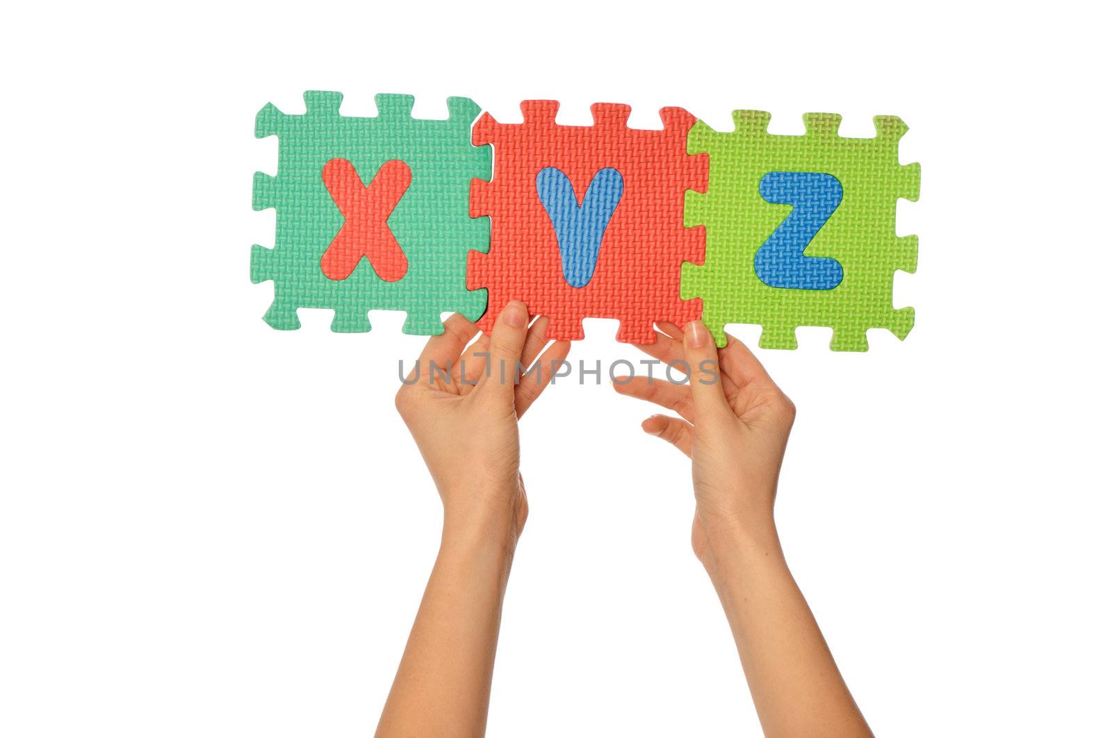 teacher holding in the hand the amusing colored educational puzzles with alphabet