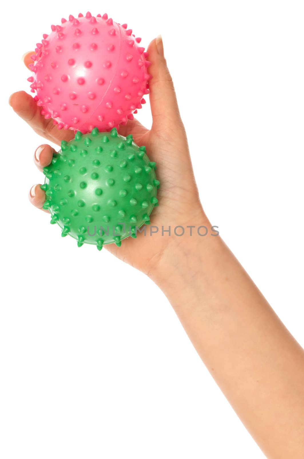 Mother stretches two massage balls for the children's hands development to her baby