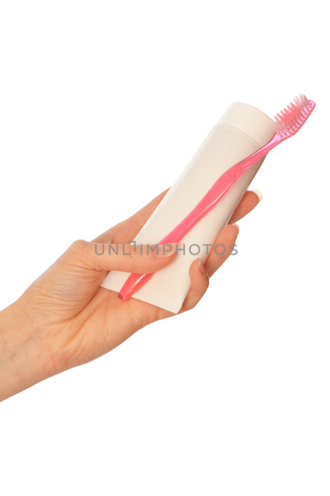 Tooth-paste and brush at in the girl's hand