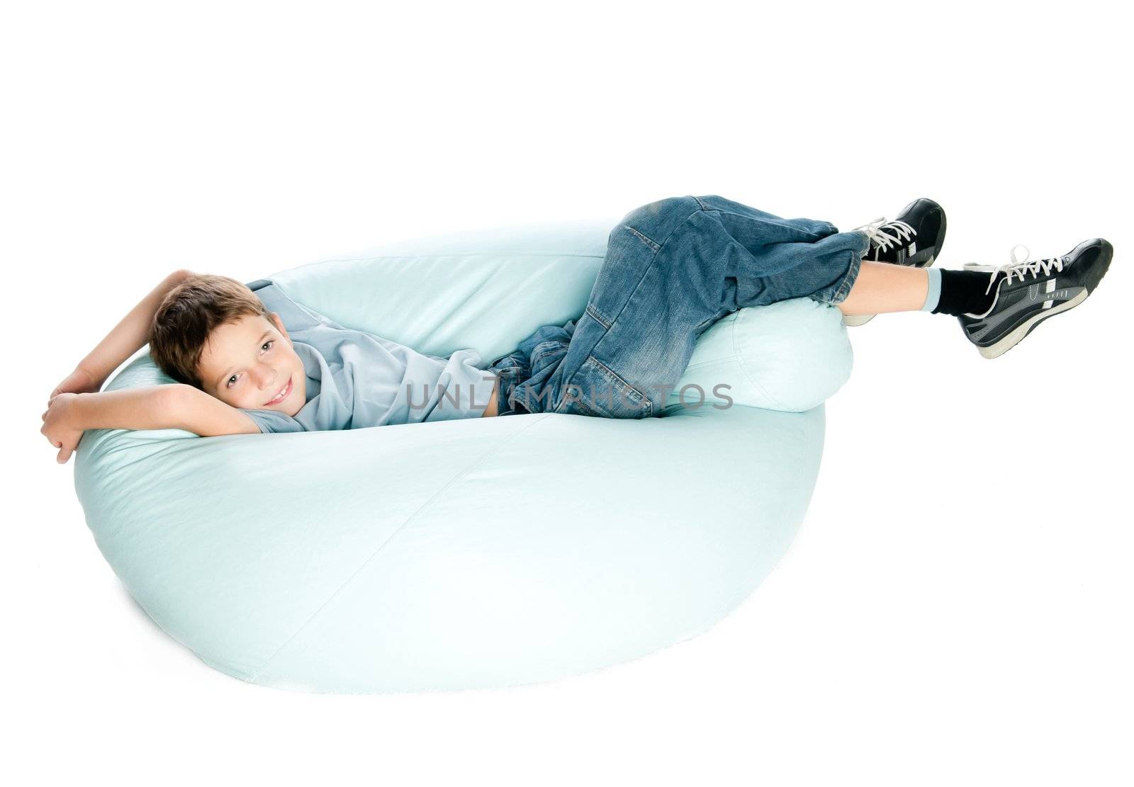 smiling Boy on armchair over white background