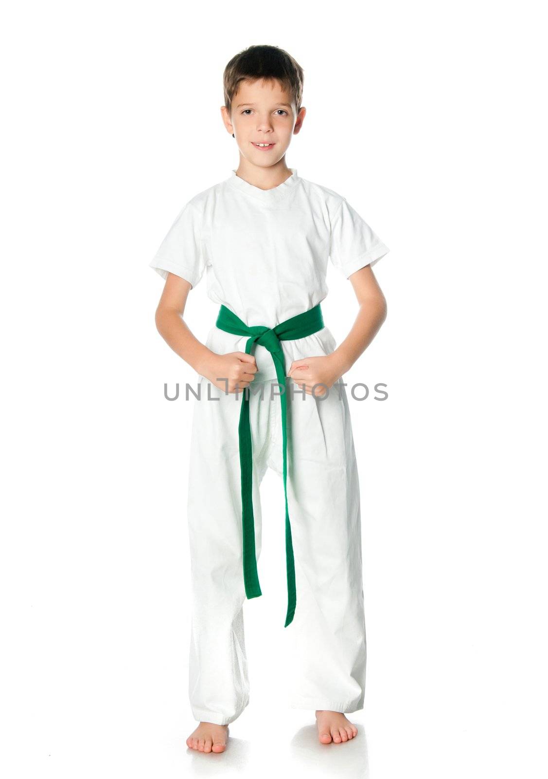 Young boy in kimono with green belt  on a white background