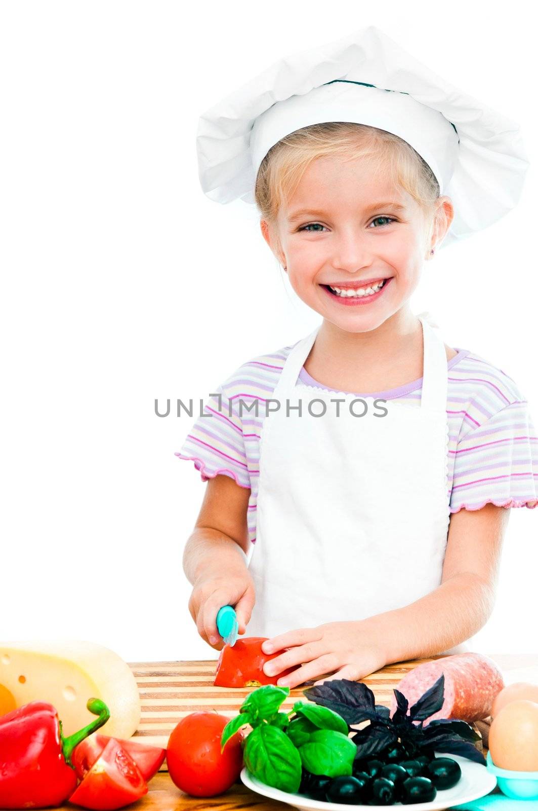 cute little girl little girl cuting tomato on a white