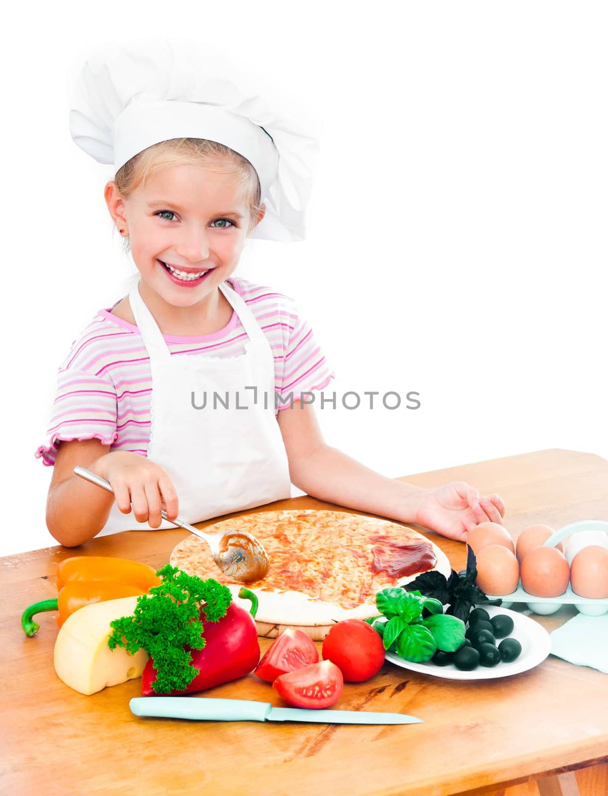 Young girl preparing a pizza on a white background