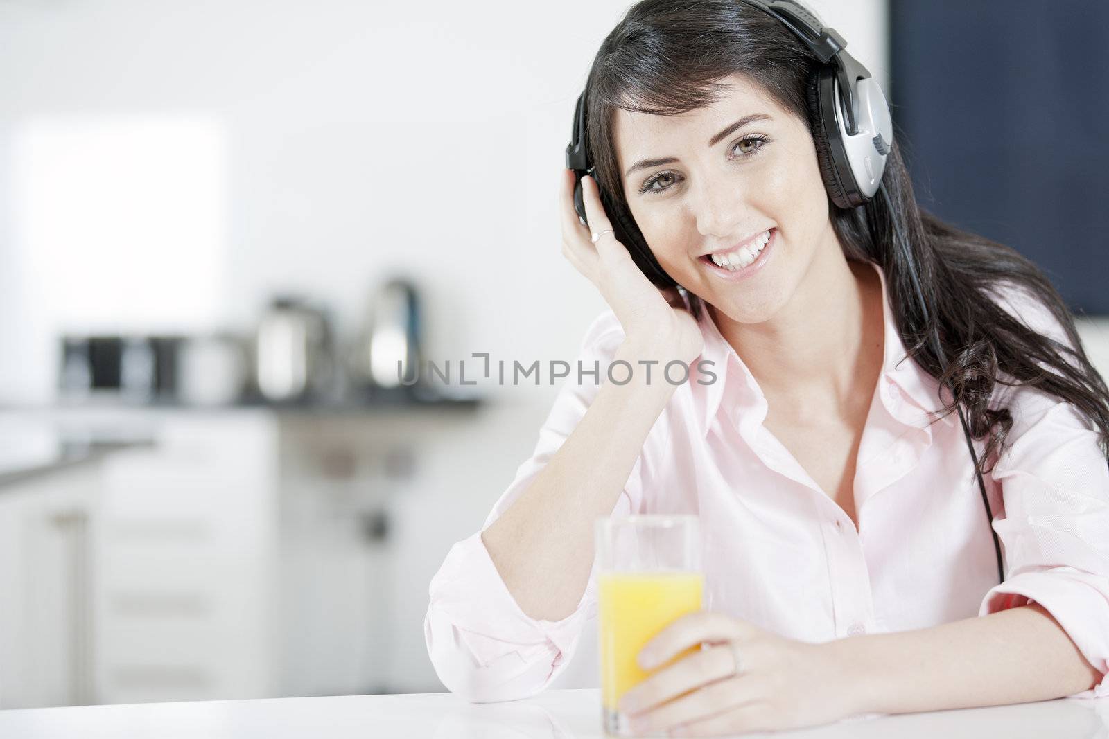 Young woman listening to music by studiofi