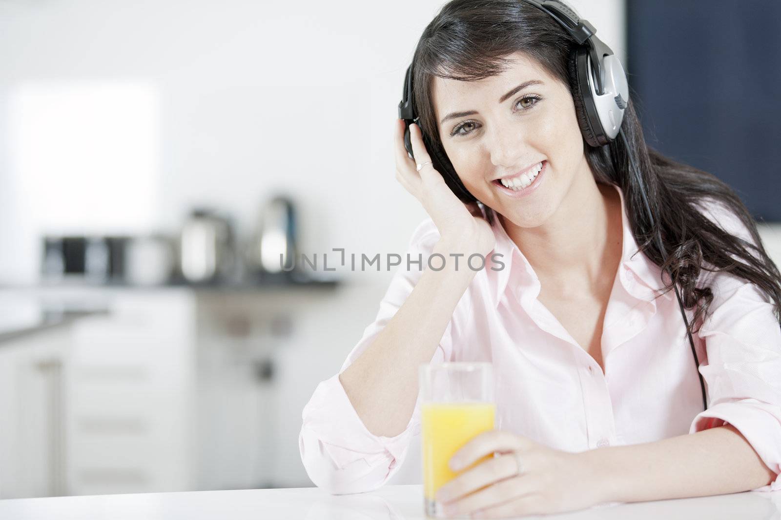 Young woman listening to music with headphones at home.