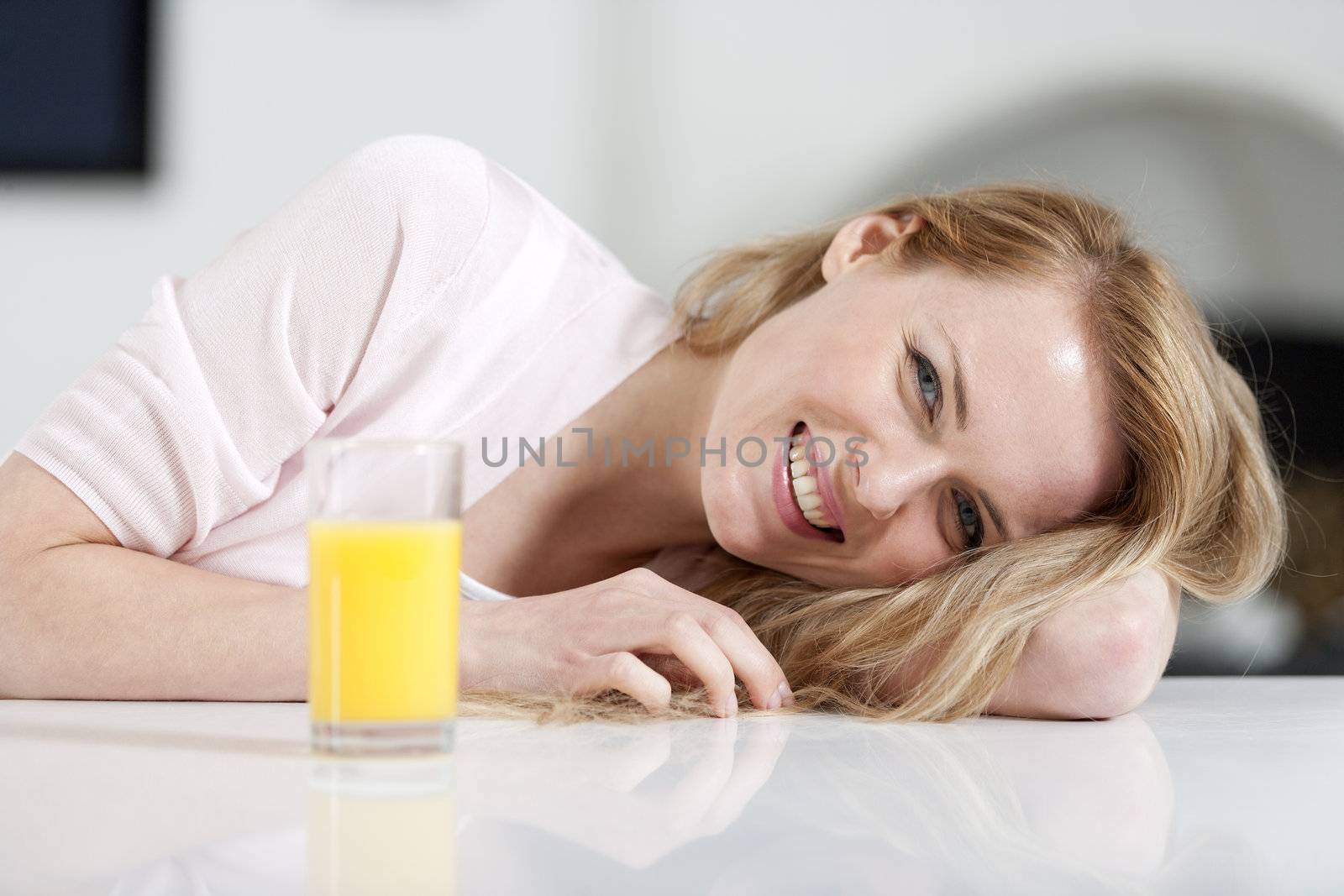 Young woman sat at table  by studiofi