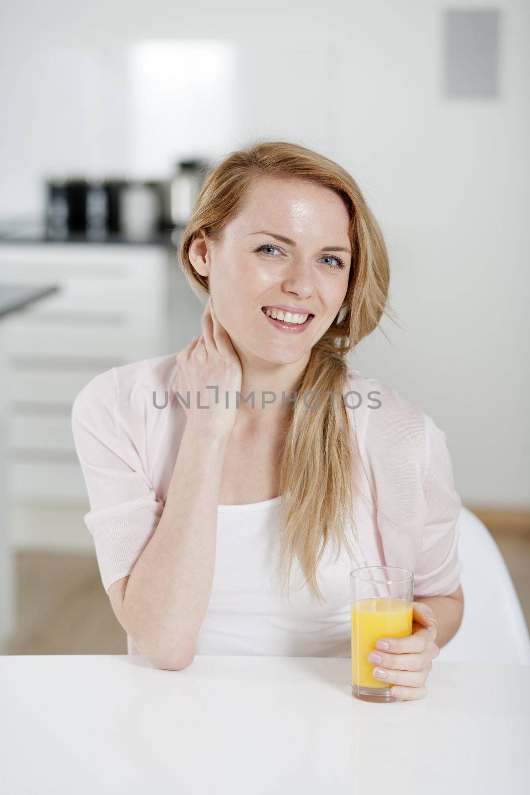 Young woman sat at table  by studiofi