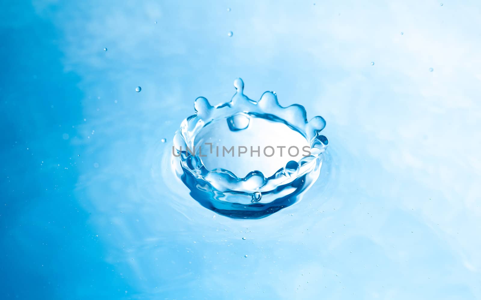 Shape of drop of water splash blue color