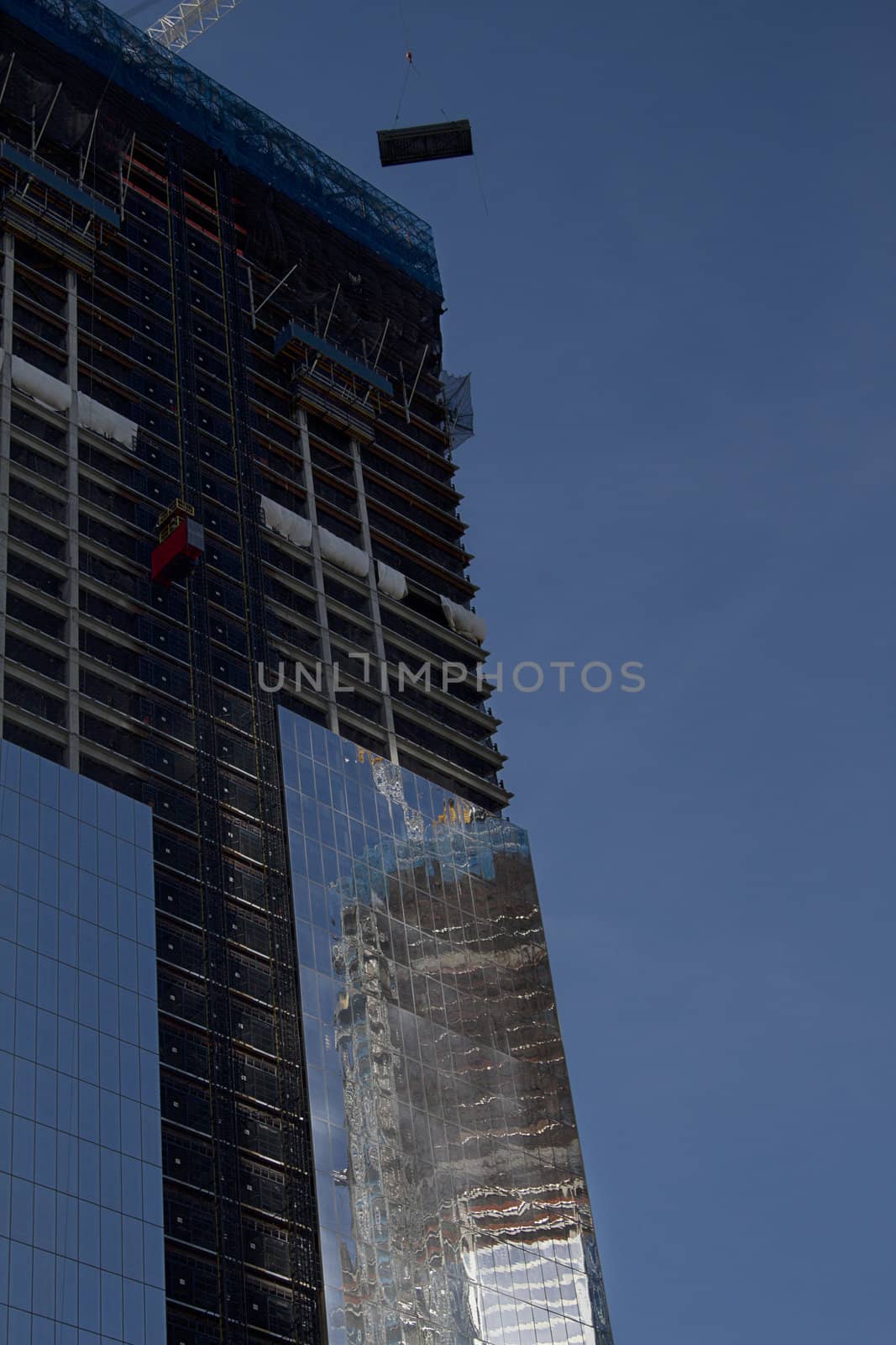 Freedom tower under construction against a blue sky