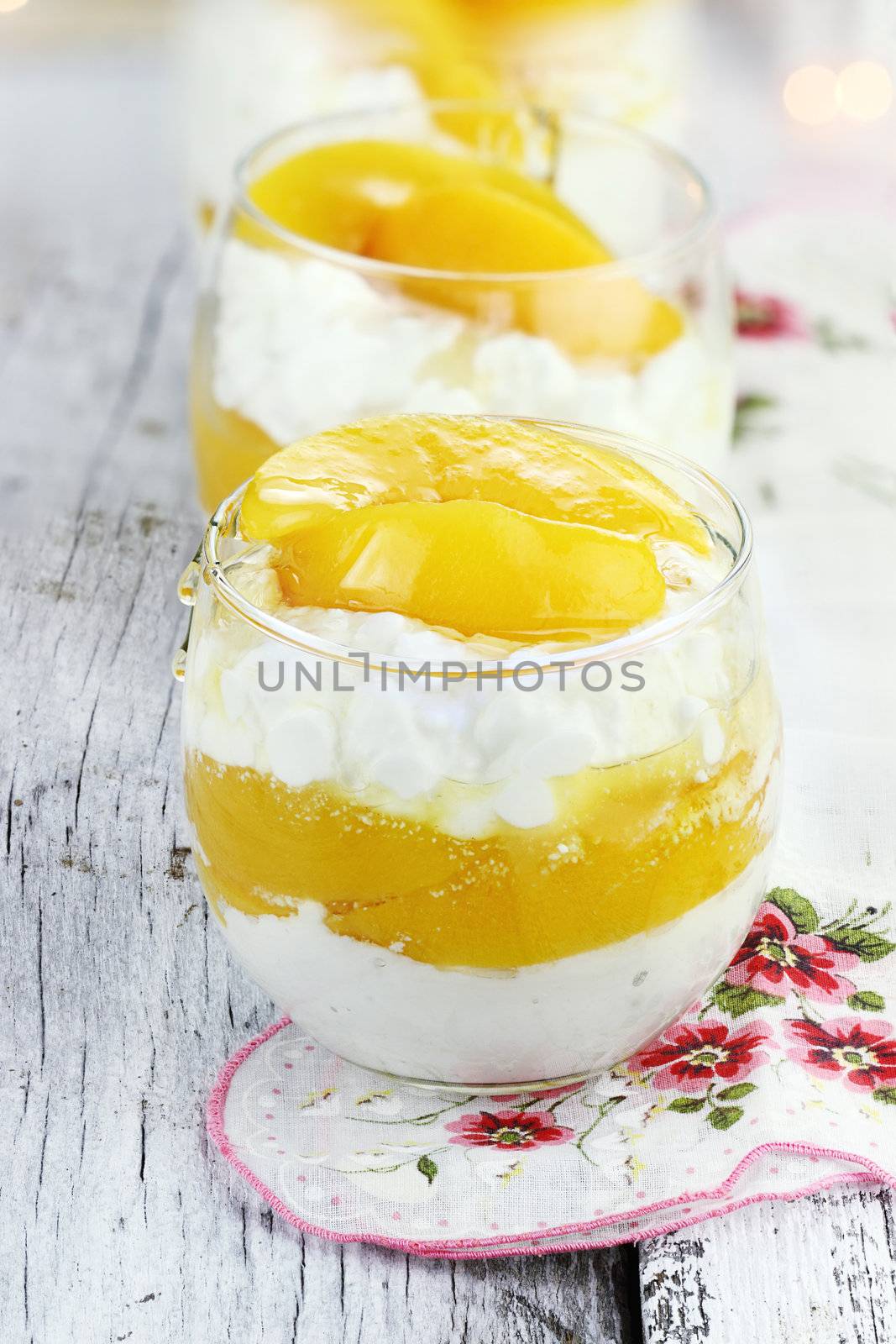 Cottage cheese with fresh peaches and honey on a rustic background. Shallow depth of field. 