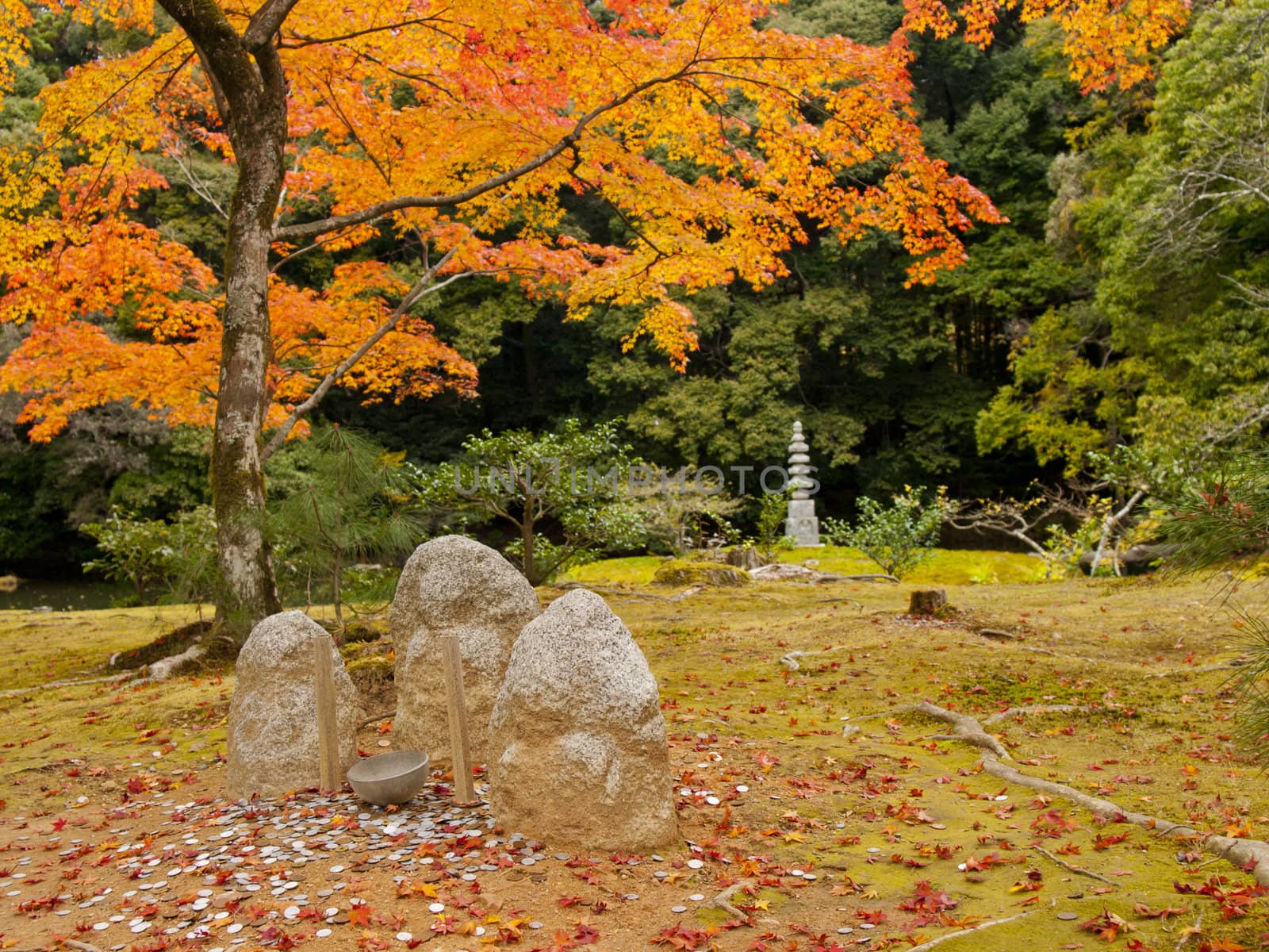 Stone statuary and a rock pagoda in Kinkakuji temple (The gloden pavilion temple) in Kyoto, Japan