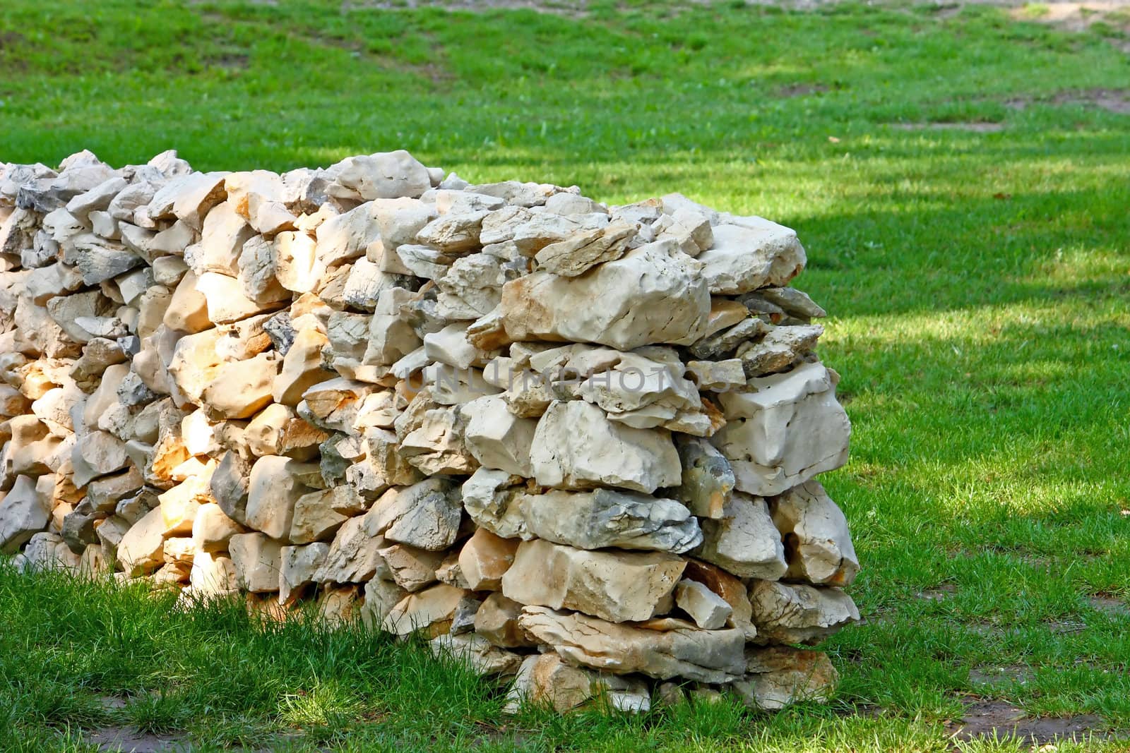 Garden stone wall in the grass