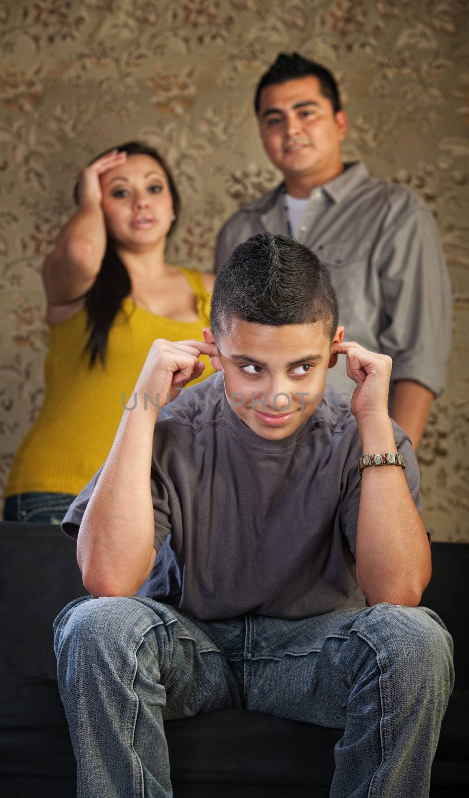 Frustrated parents and child with ears plugged