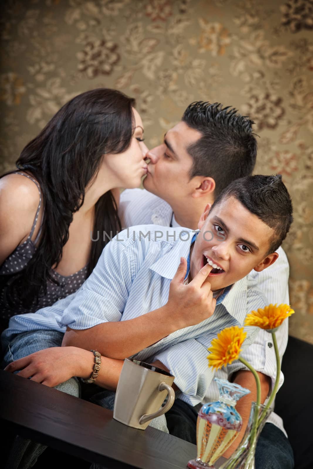 Grossed out child in front of kissing parents