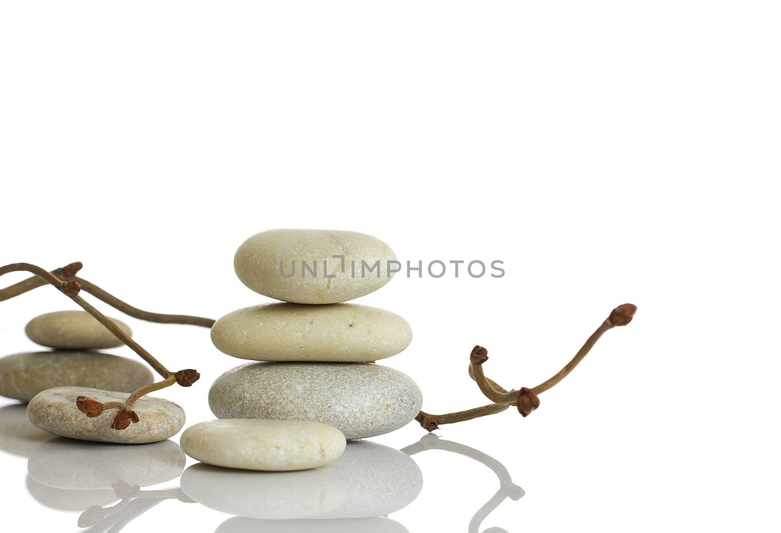 Spa stones and dry hazel branches, isolated on white background.