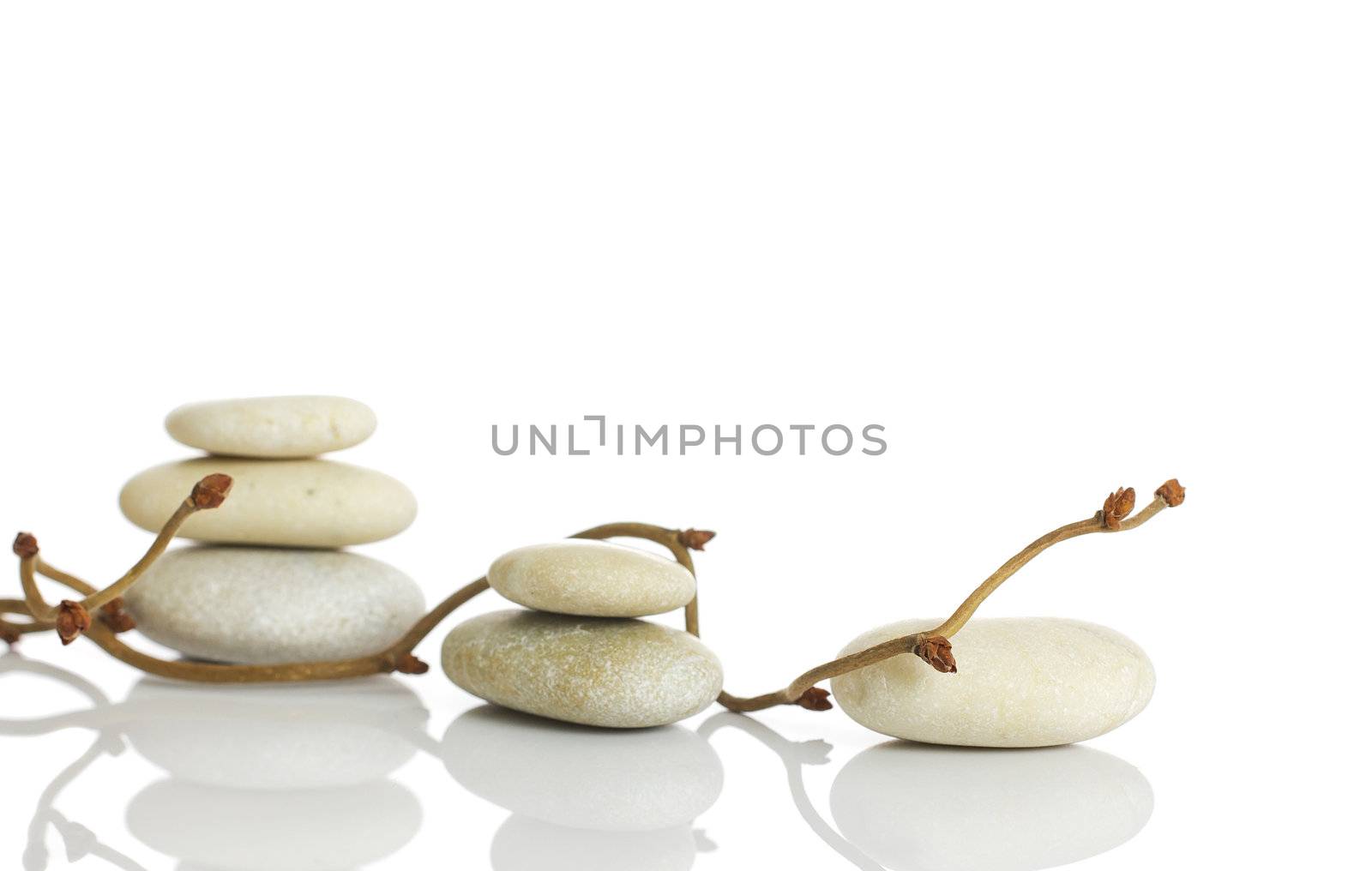 Spa stones and dry hazel branches, isolated on white background.